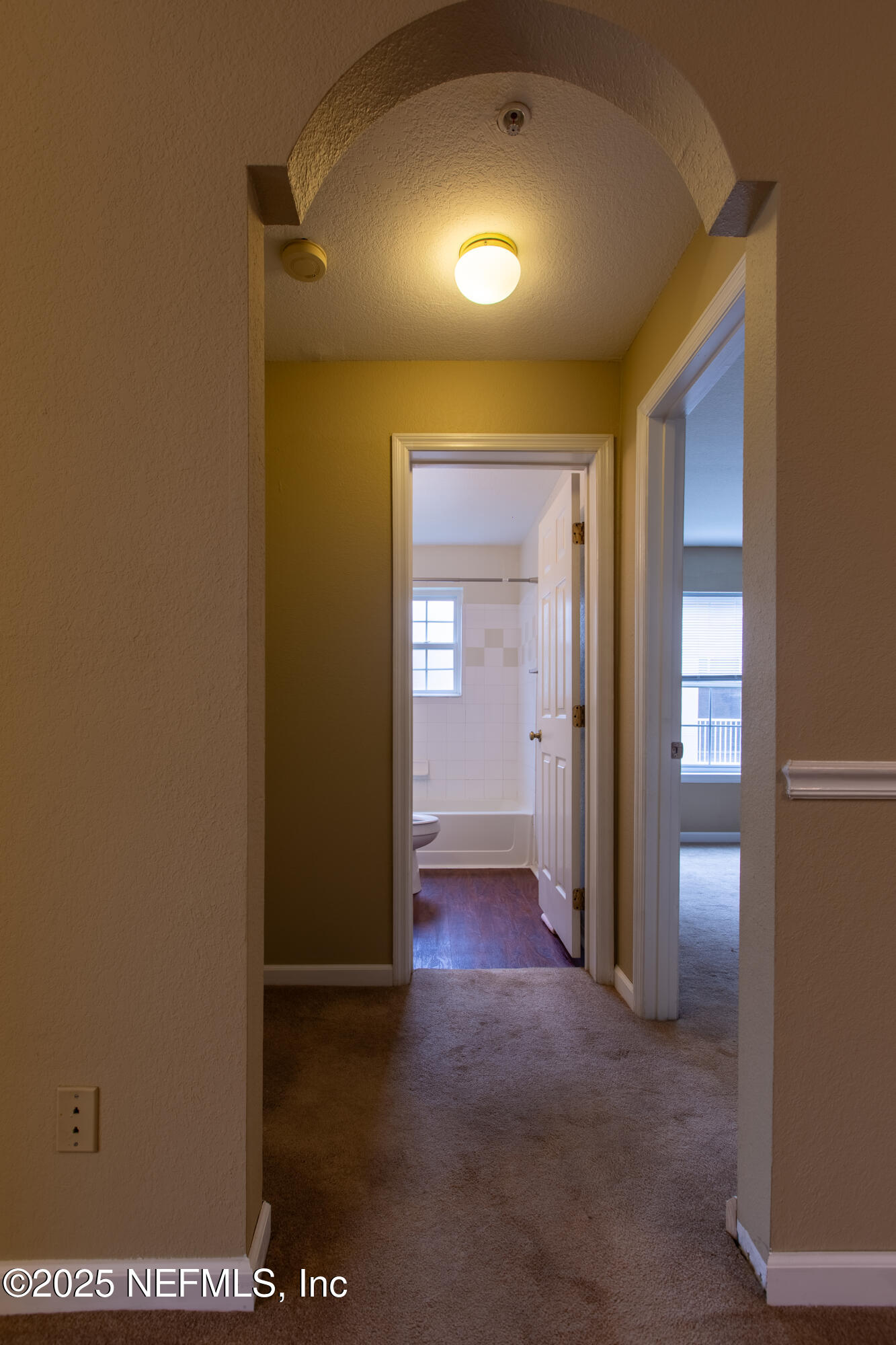 13810 Sutton Park Drive North, Unit 1120 Jacksonville, FL 32224 - Photo 14 of 24 a view of a hallway with wooden shelves