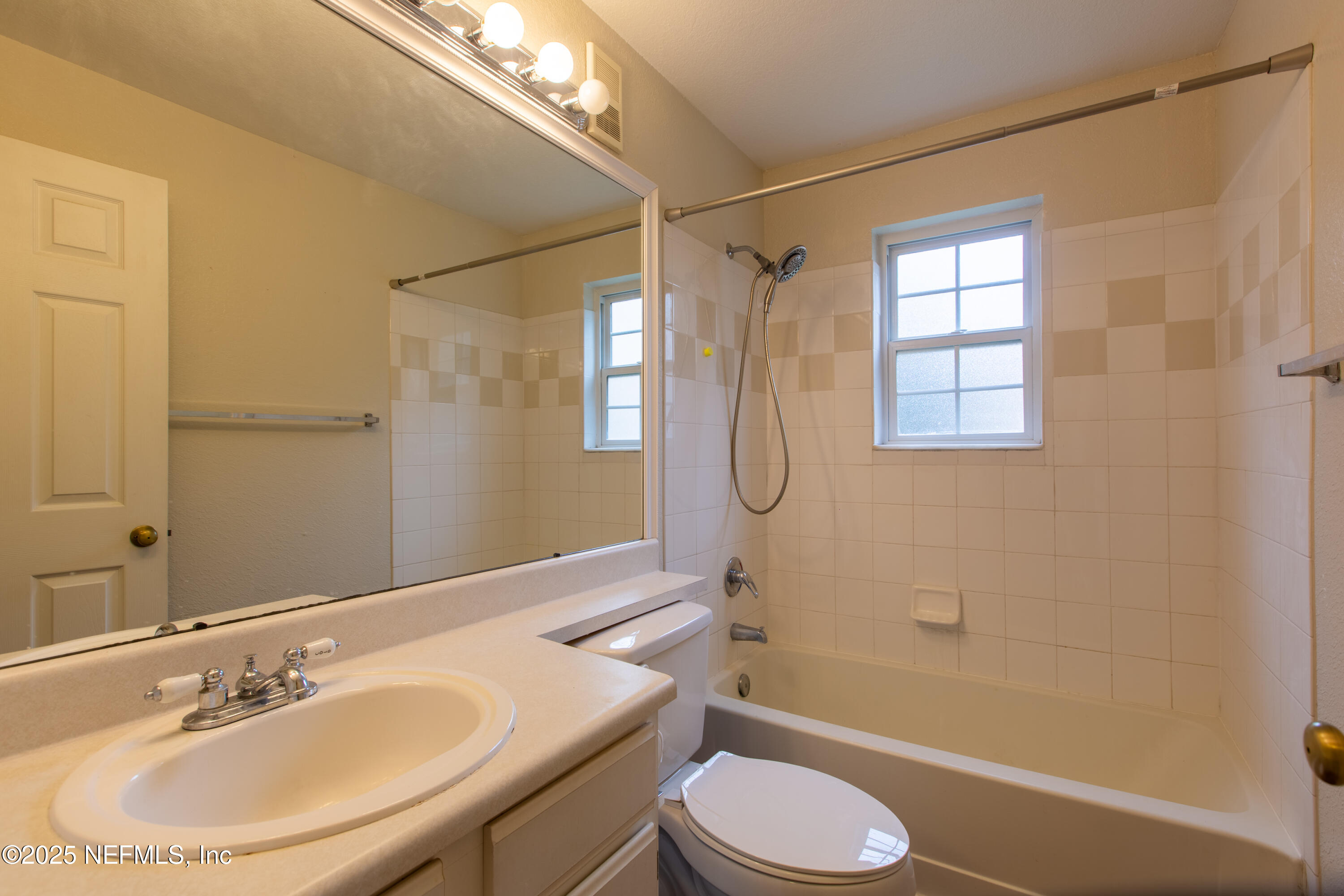13810 Sutton Park Drive North, Unit 1120 Jacksonville, FL 32224 - Photo 20 of 24 a bathroom with a sink toilet and shower