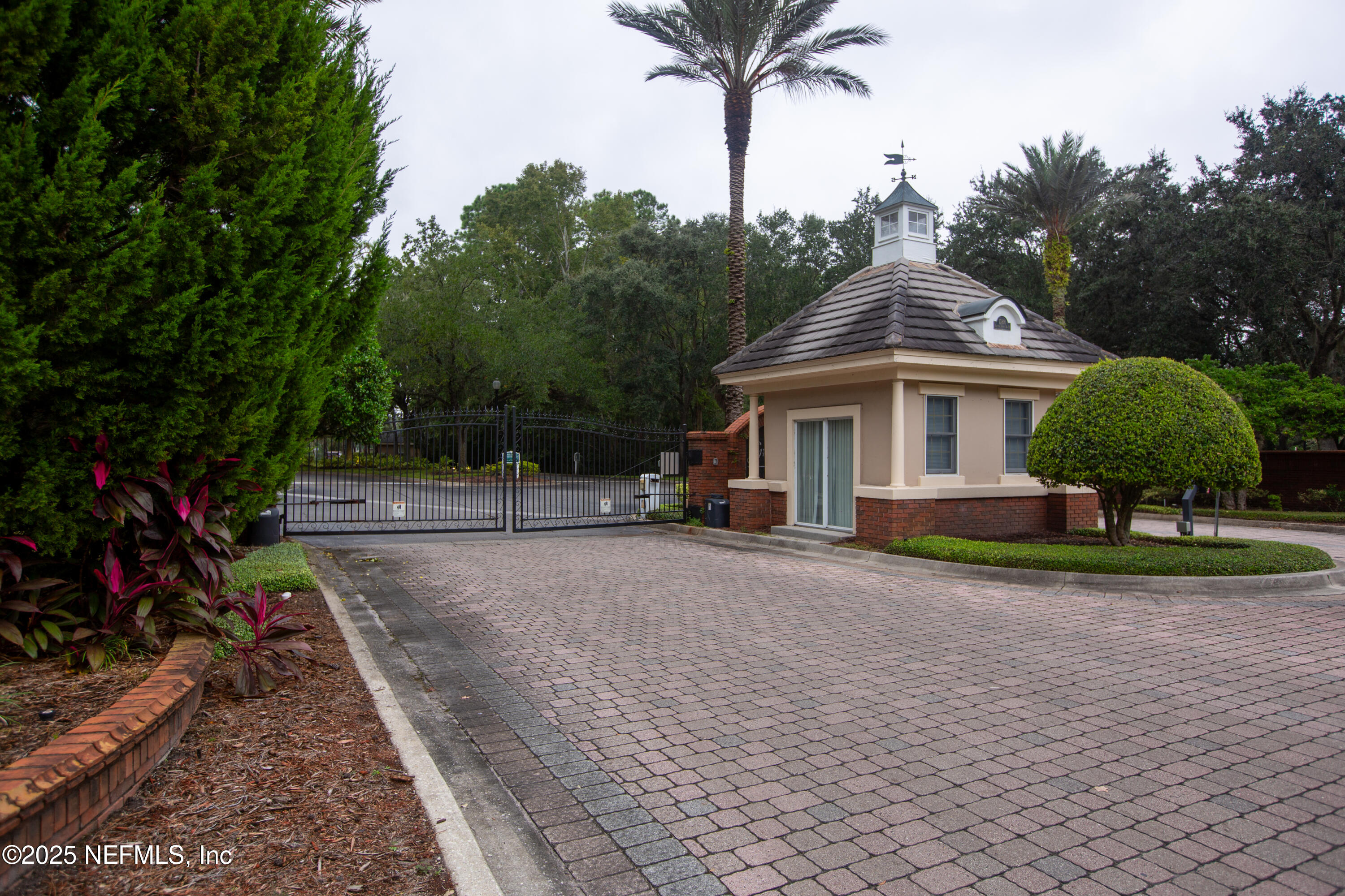 13810 Sutton Park Drive North, Unit 1120 Jacksonville, FL 32224 - Photo 2 of 24 a front view of a house with a yard and palm trees