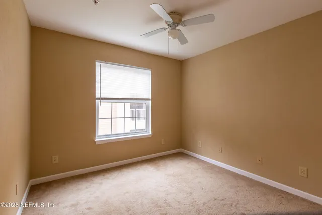 a view of a white house with a swimming pool and a yard