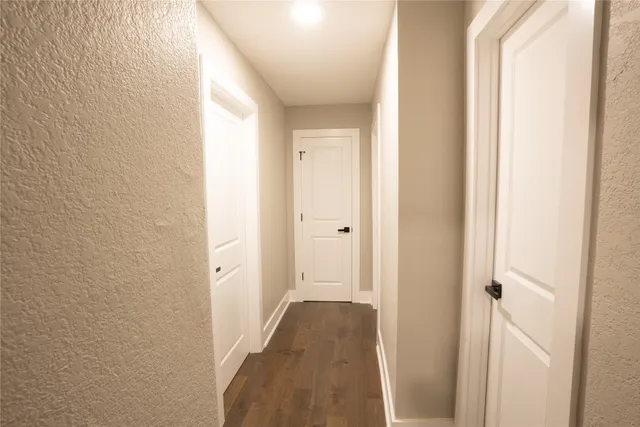 a view of a hallway with a wooden floor