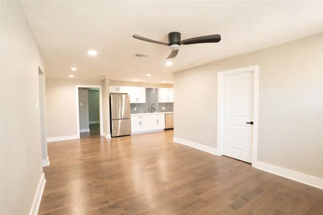 a view of a kitchen with a refrigerator and a sink