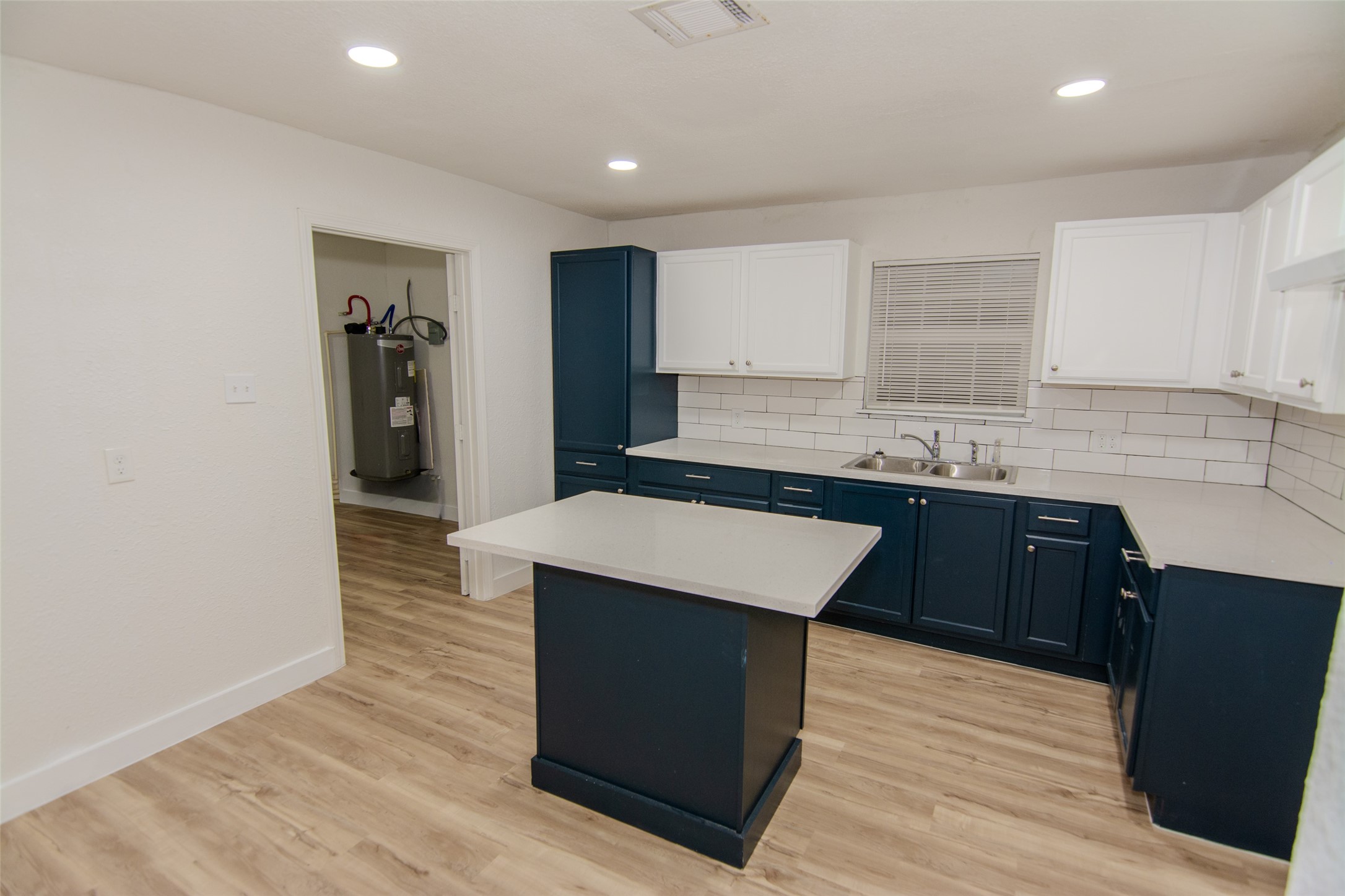 10815 Ritow Street Houston, TX 77089 - Photo 5 of 12 a kitchen with kitchen island stainless steel appliances a sink stove and refrigerator