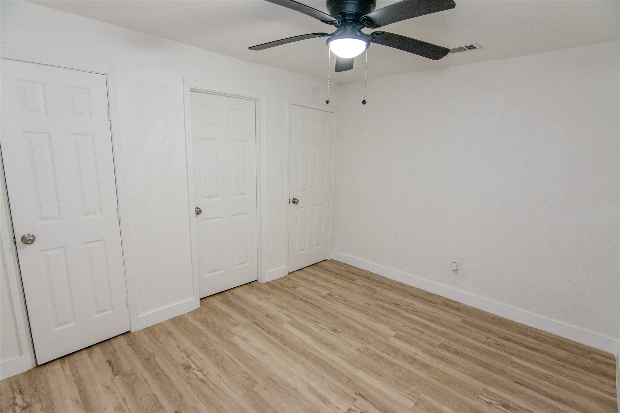 10815 Ritow Street Houston, TX 77089 - Photo 10 of 12 a view of an empty room with wooden floor