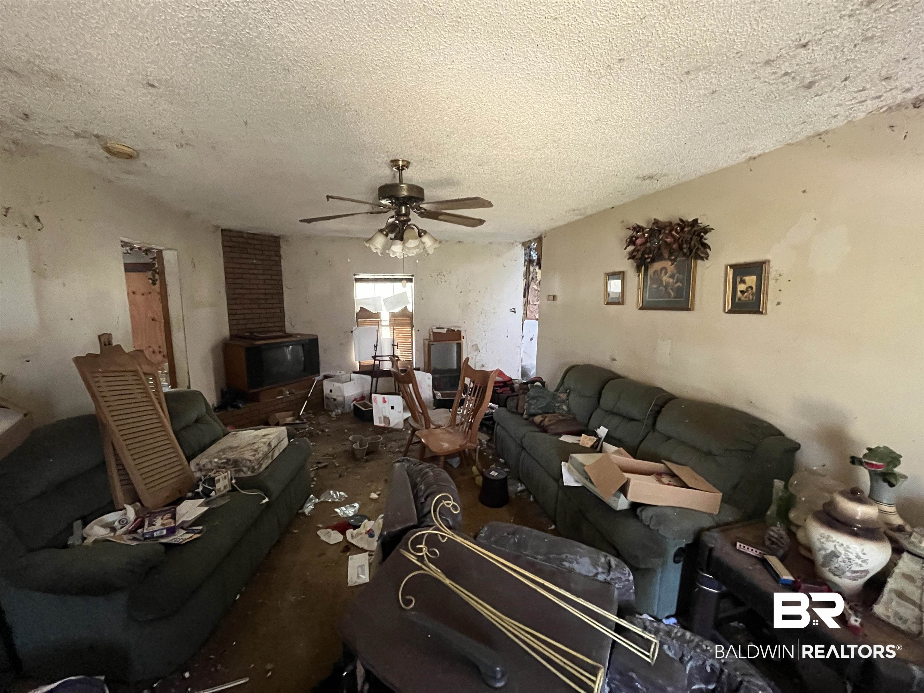 108 Powell Avenue Bay Minette, AL 36507 - Photo 22 of 39 Living room featuring ceiling fan and a textured ceiling