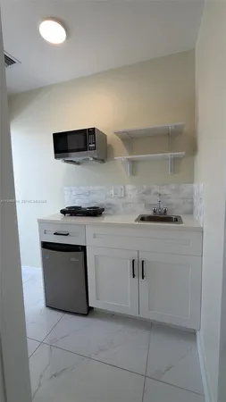 a kitchen with stainless steel appliances granite countertop a sink and a stove