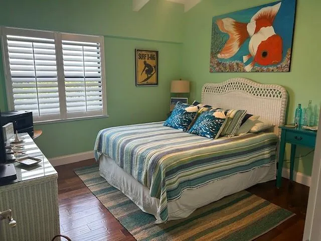 a bedroom with a bed and wall painting on the wall