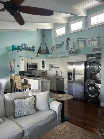 a living room with furniture and a kitchen view
