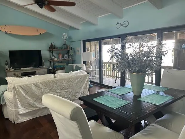 a living room with couches a coffee table and a flat screen tv