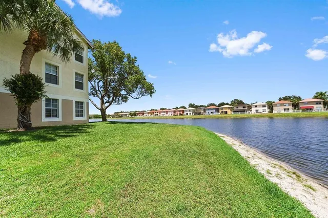 a view of a house with a garden and lake view
