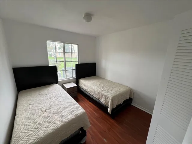 a bedroom with two beds and a window