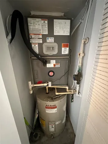 a room with water heater refrigerator washer and dryer