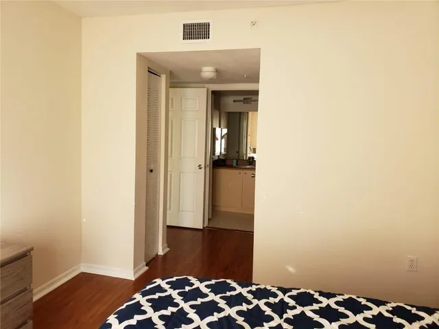 a view of bedroom with wooden floor