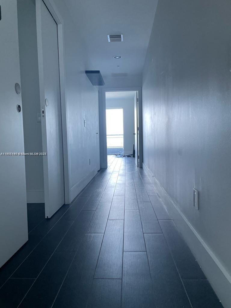 60 Southwest 13th Street, Unit 3606 Miami, FL 33130 - Photo 11 of 22 a view of a hallway with wooden floor