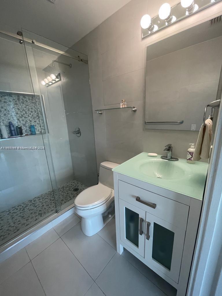 60 Southwest 13th Street, Unit 3606 Miami, FL 33130 - Photo 15 of 22 a bathroom with a sink a toilet and shower