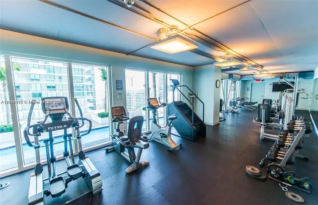 a view of a livingroom with furniture wooden floor and a floor to ceiling window