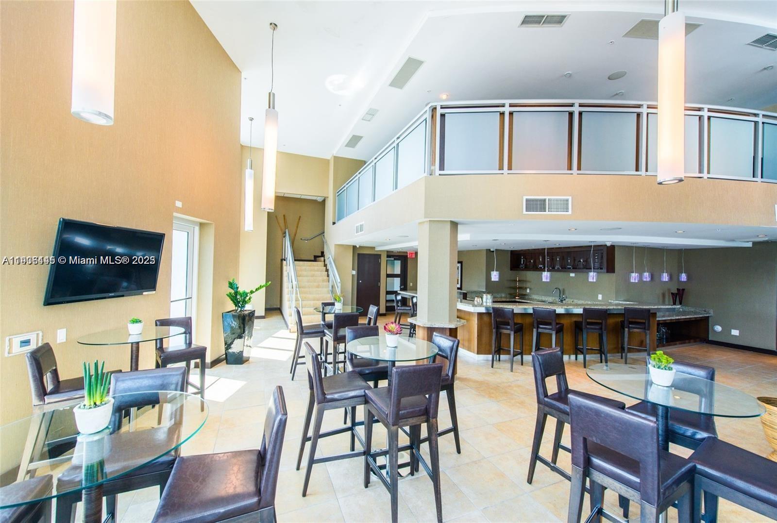 60 Southwest 13th Street, Unit 3606 Miami, FL 33130 - Photo 21 of 22 a view of a dining room with furniture and wooden floor
