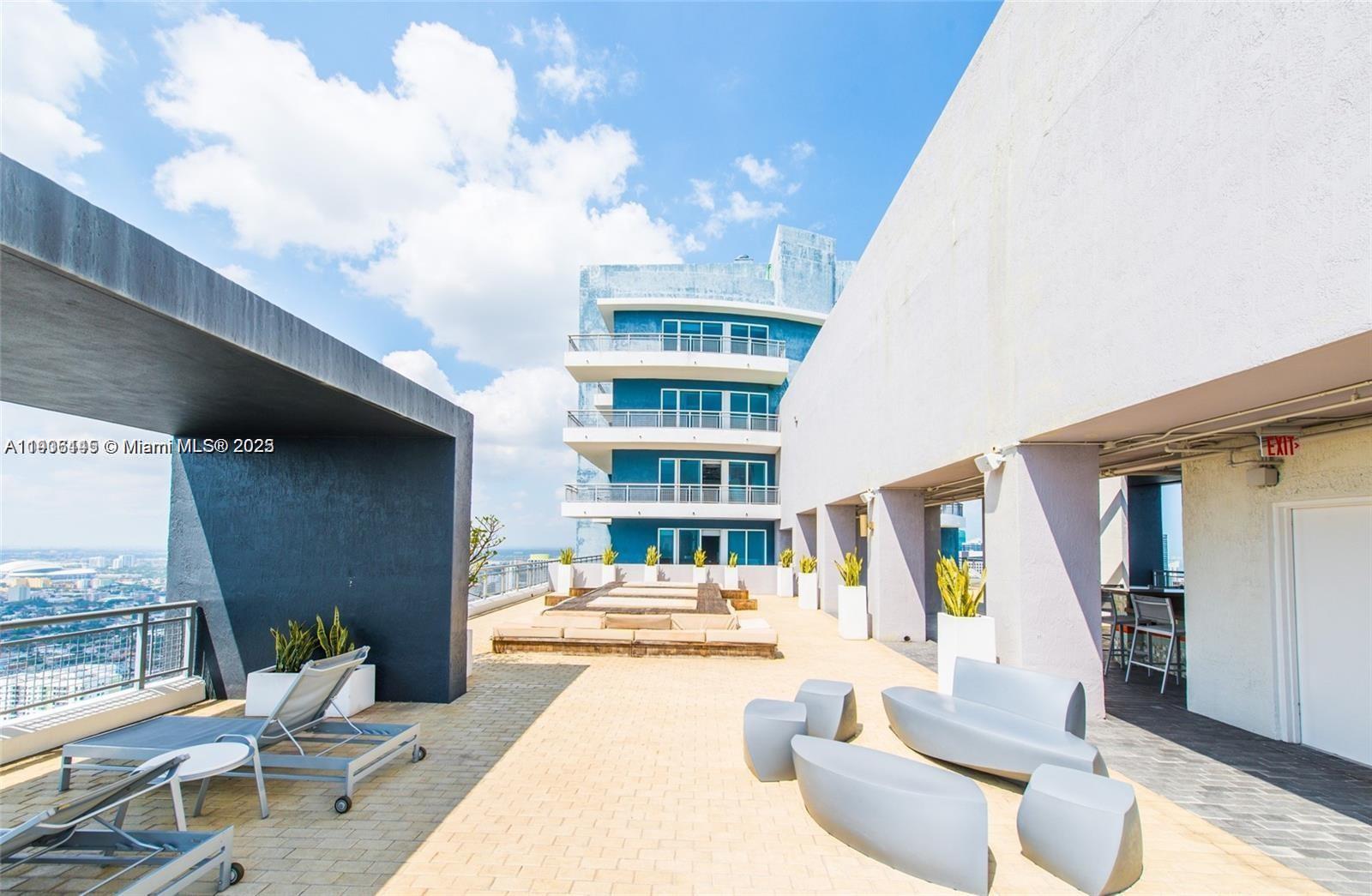 60 Southwest 13th Street, Unit 3606 Miami, FL 33130 - Photo 22 of 22 a living room with furniture and a large window