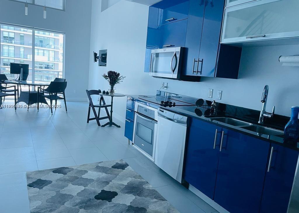 60 Southwest 13th Street, Unit 3606 Miami, FL 33130 - Photo 3 of 22 a kitchen with sink cabinets and window