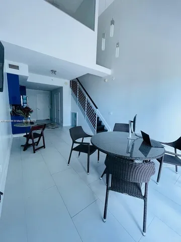 a living room with furniture and a rug