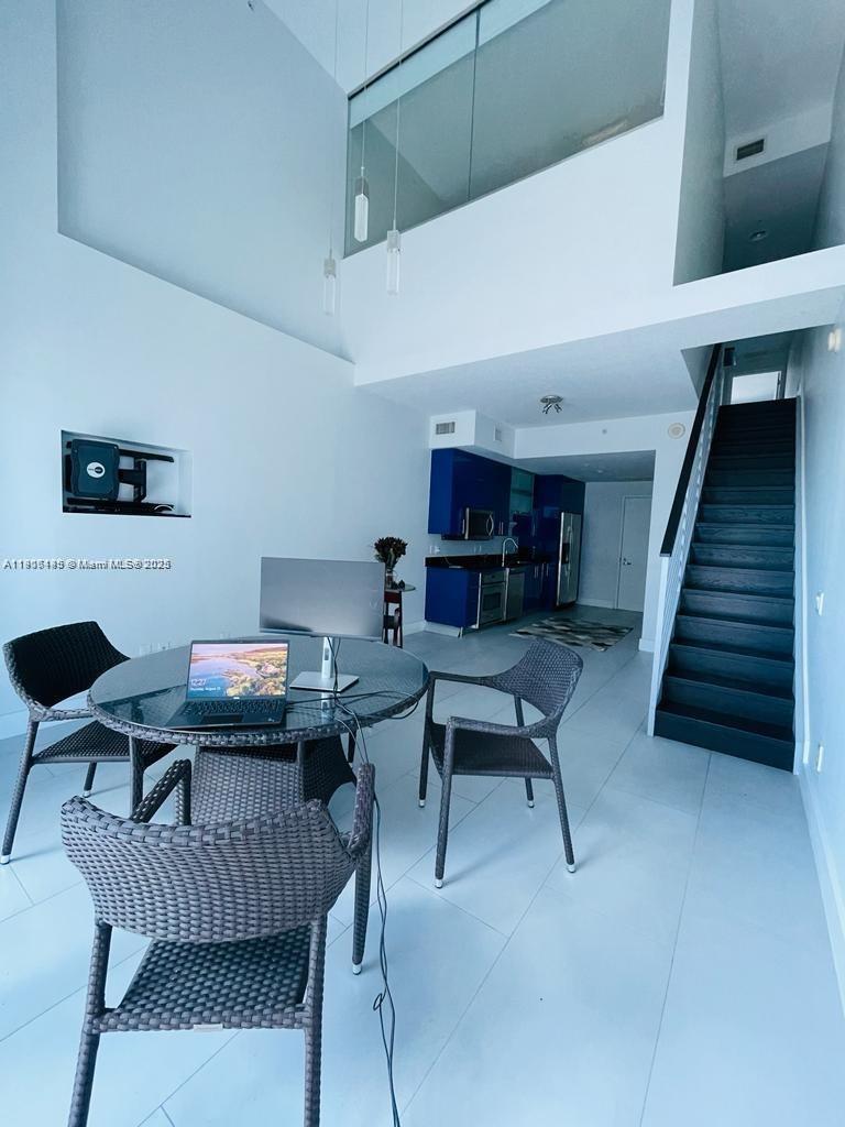 60 Southwest 13th Street, Unit 3606 Miami, FL 33130 - Photo 5 of 22 a work room with furniture and wooden floor