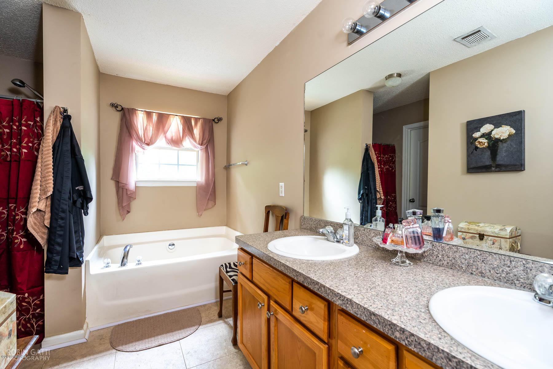 234 Autumn Ridge Court Gray, GA 31032 - Photo 16 of 24 a bathroom with a granite countertop tub sink and mirror