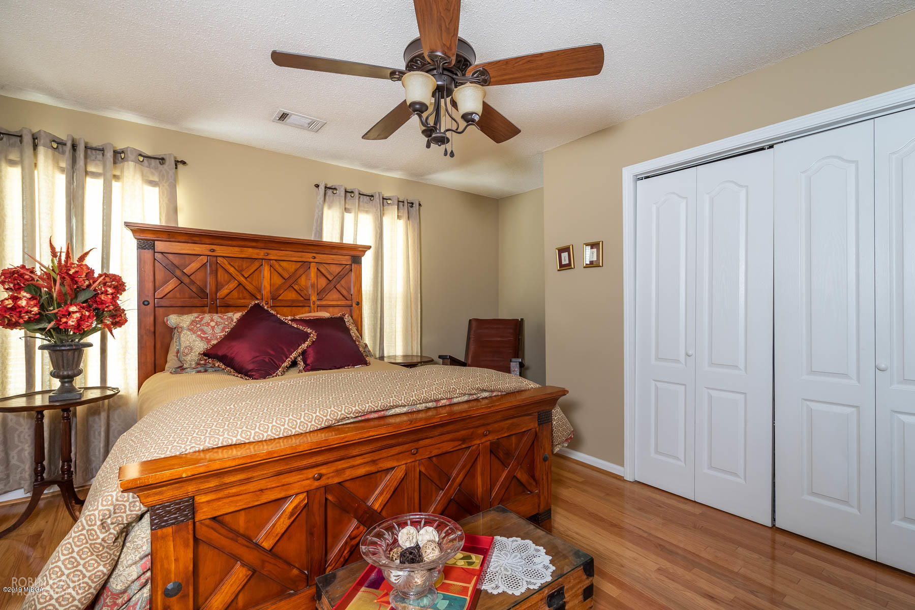 234 Autumn Ridge Court Gray, GA 31032 - Photo 20 of 24 a bedroom with a bed and a chandelier