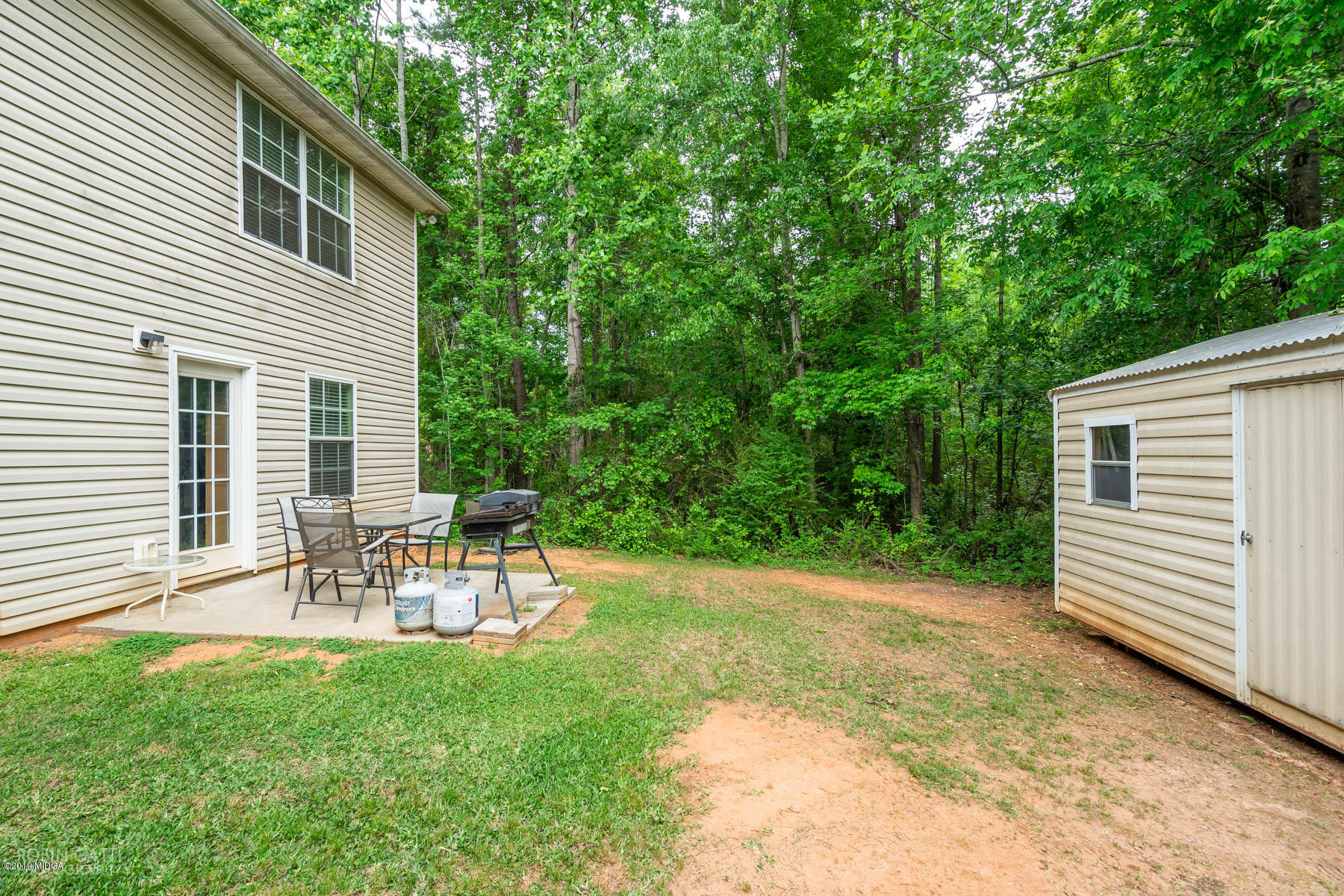 234 Autumn Ridge Court Gray, GA 31032 - Photo 24 of 24 a view of a chair and table in backyard of the house