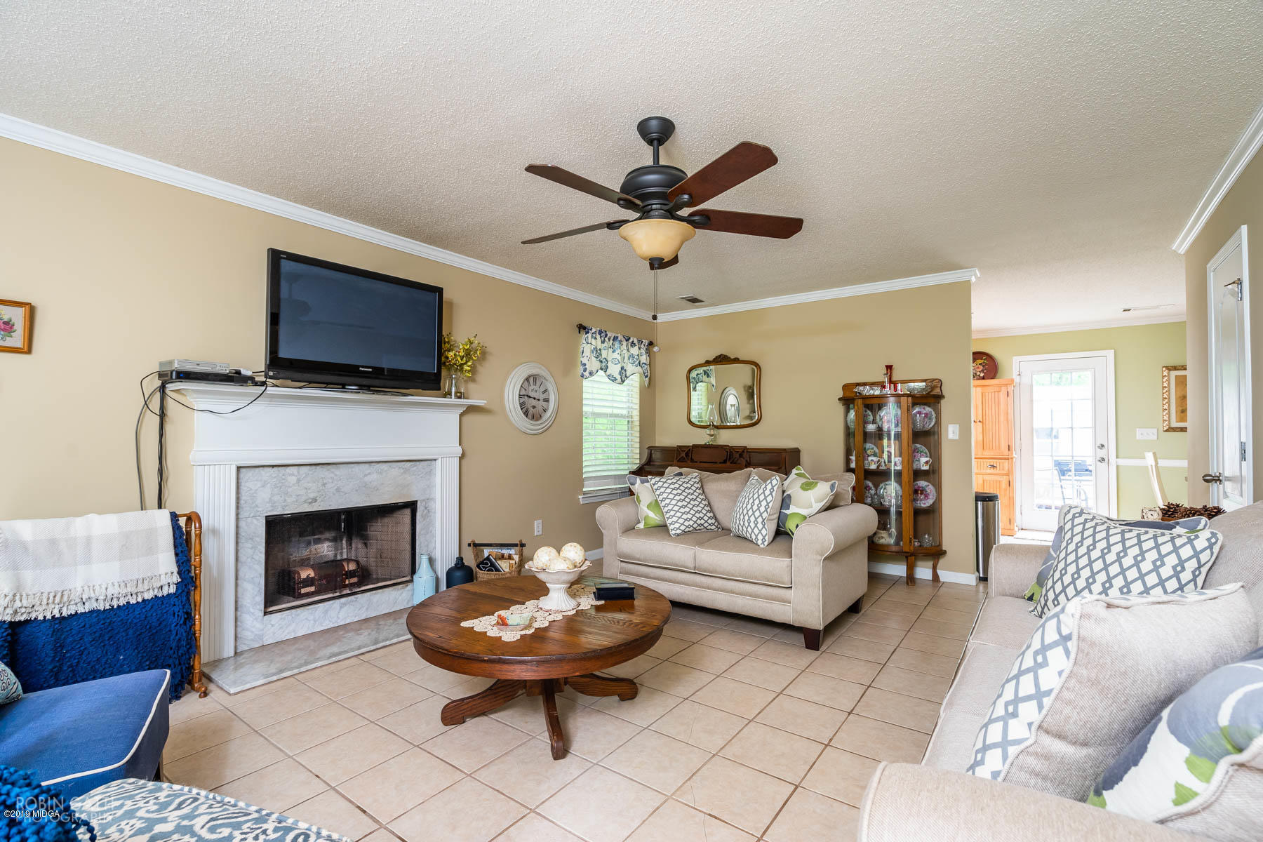 234 Autumn Ridge Court Gray, GA 31032 - Photo 5 of 24 a living room with furniture a flat screen tv and a fireplace