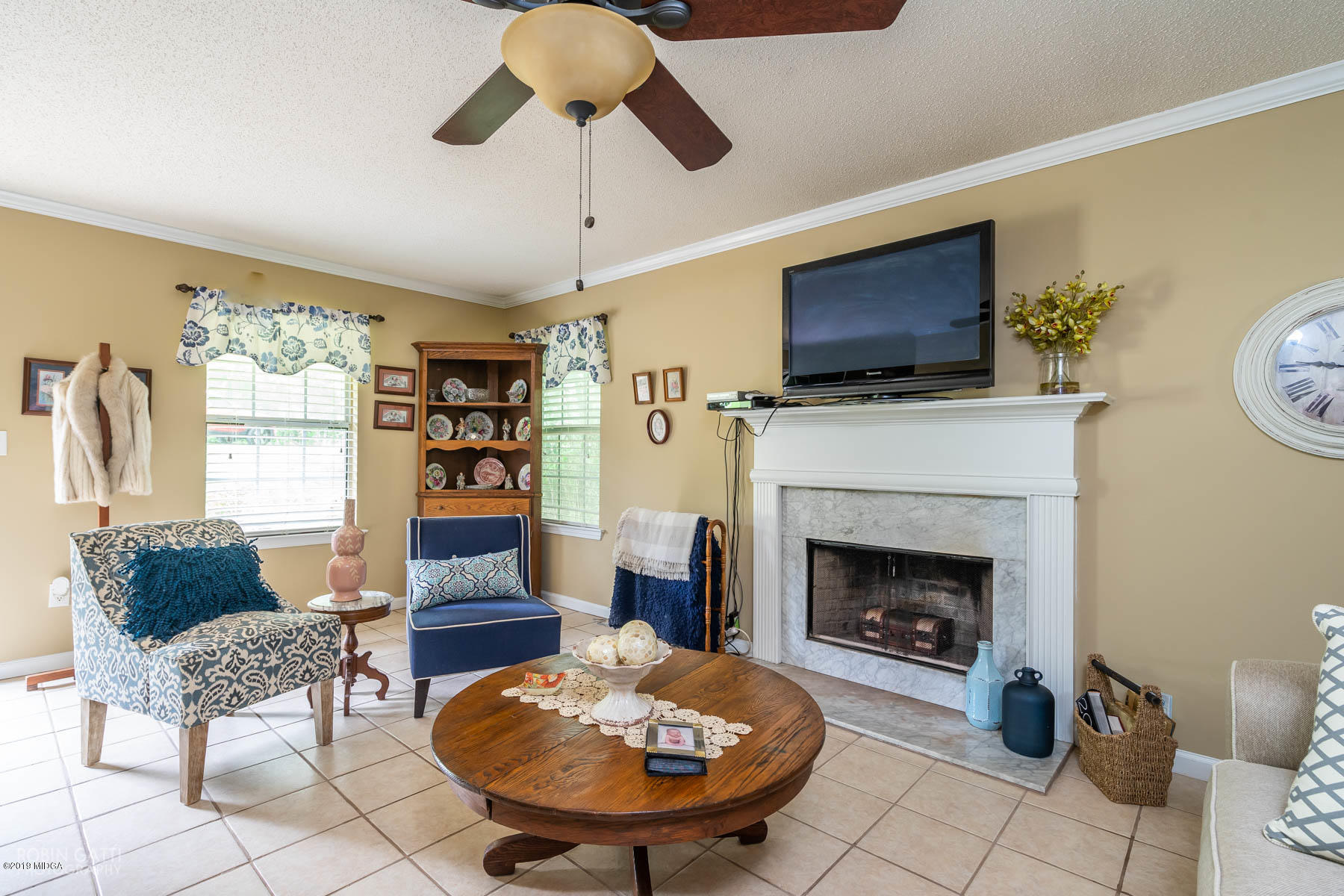 234 Autumn Ridge Court Gray, GA 31032 - Photo 7 of 24 a living room with furniture a flat screen tv and a fireplace