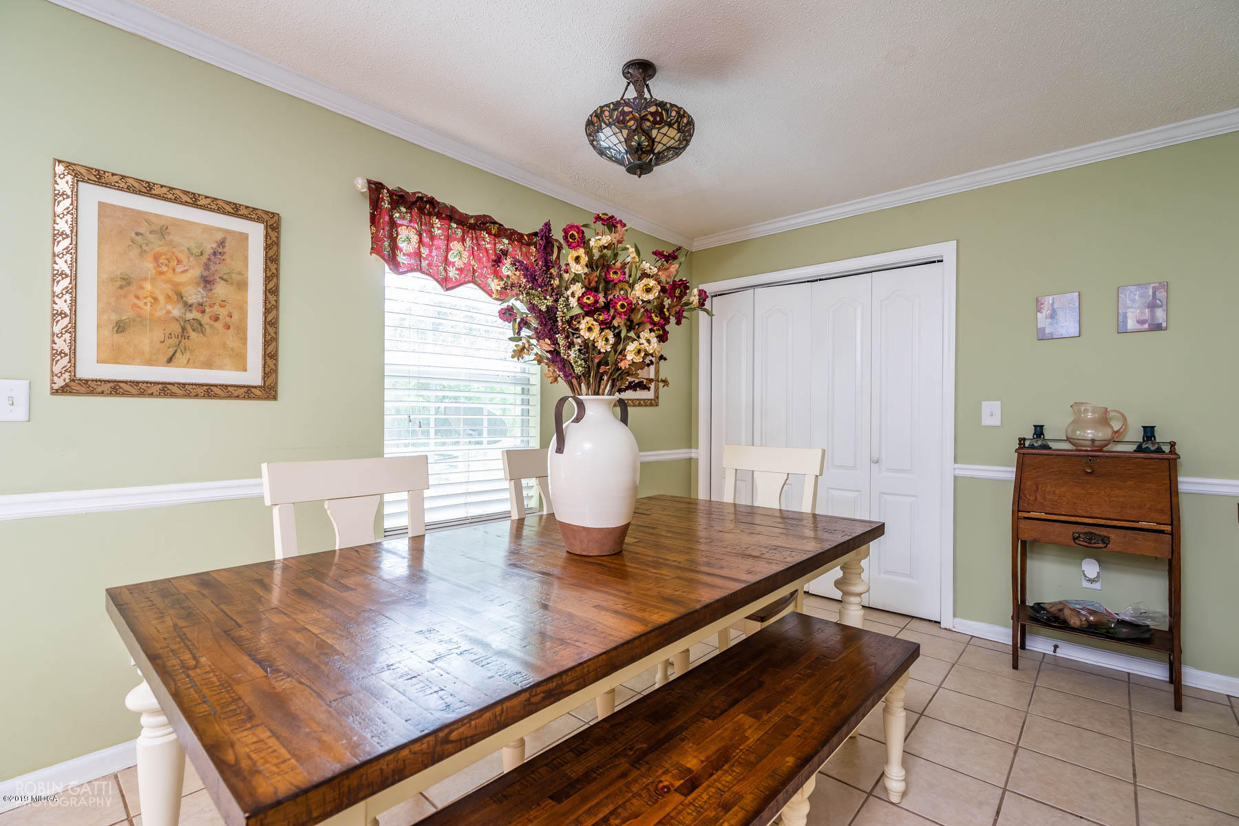 234 Autumn Ridge Court Gray, GA 31032 - Photo 9 of 24 a view of a dining room with furniture and a chandelier