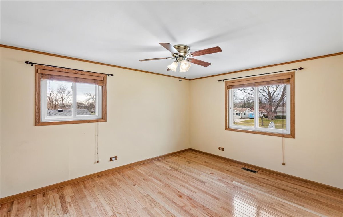 313 Springinsguth Road Schaumburg, IL 60193 - Photo 15 of 39 a view of empty room with wooden floor and fan