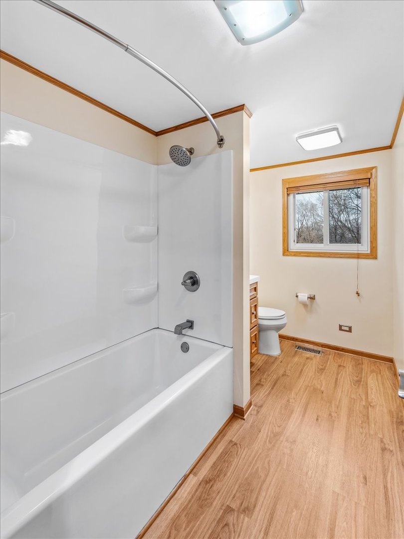 313 Springinsguth Road Schaumburg, IL 60193 - Photo 18 of 39 a bathroom with a bathtub and a shower
