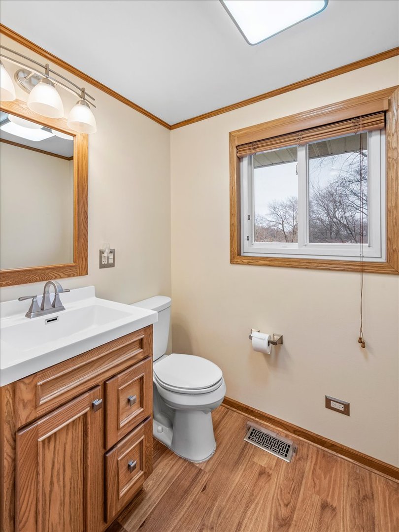 313 Springinsguth Road Schaumburg, IL 60193 - Photo 23 of 39 a bathroom with a granite countertop sink toilet and a mirror