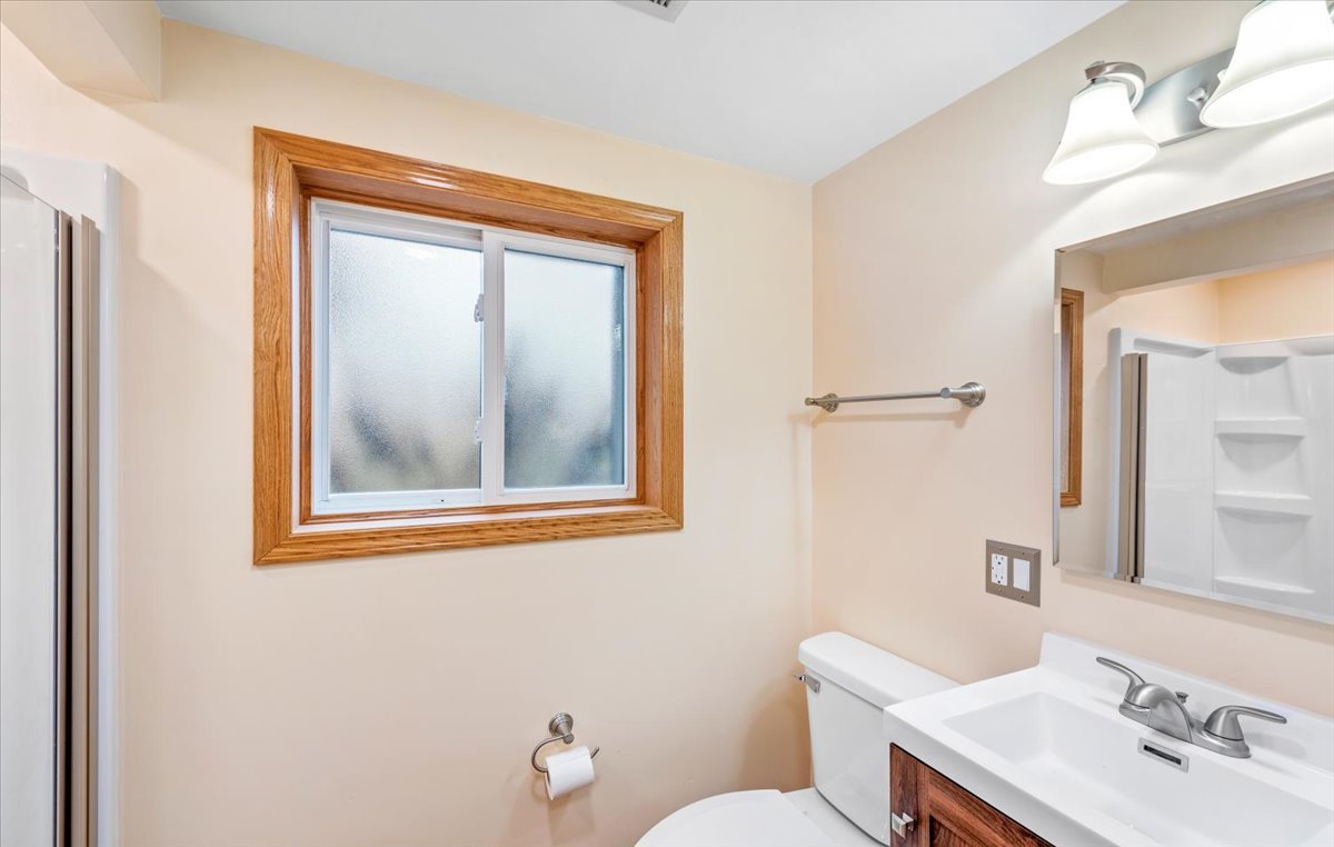 313 Springinsguth Road Schaumburg, IL 60193 - Photo 25 of 39 a bathroom with a toilet a sink and mirror