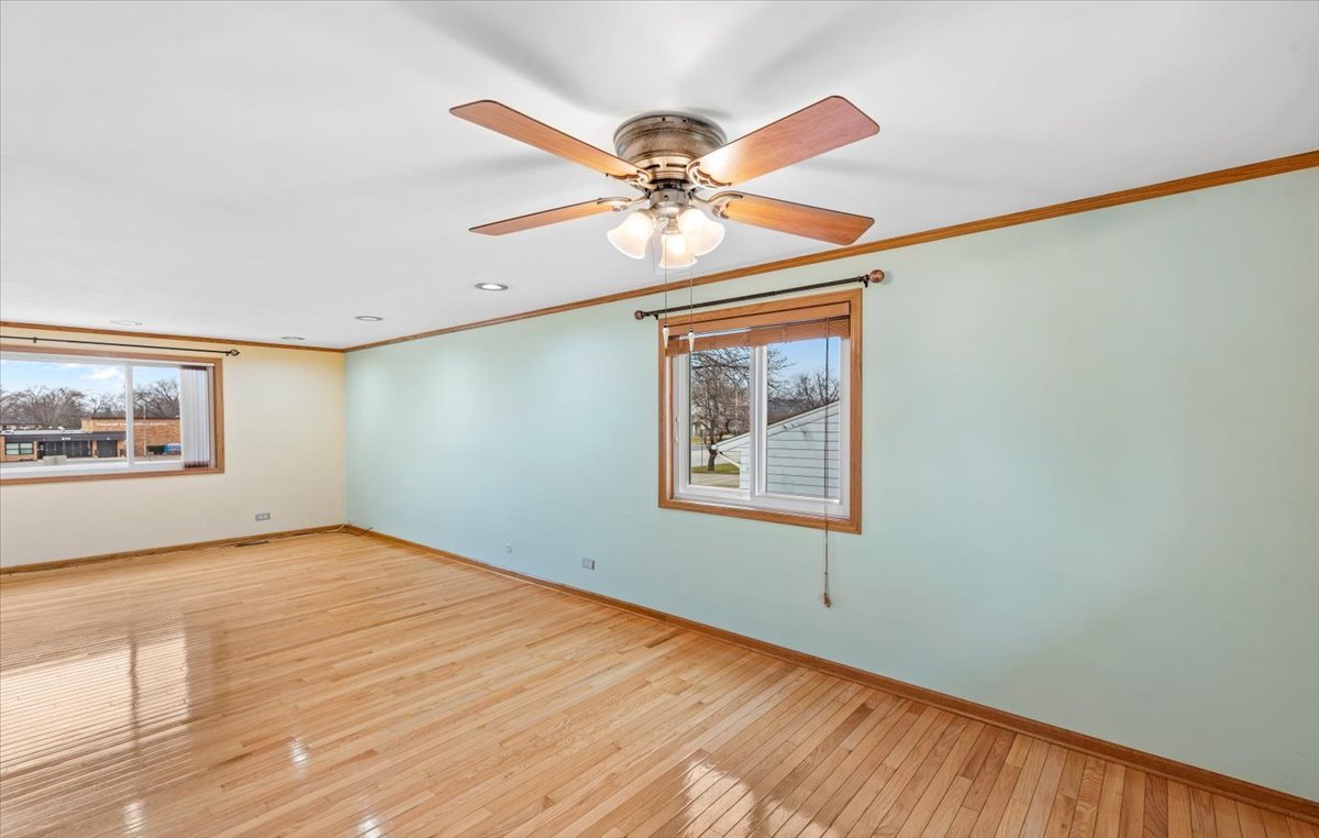 313 Springinsguth Road Schaumburg, IL 60193 - Photo 6 of 39 a view of an empty room with window and a chandelier fan