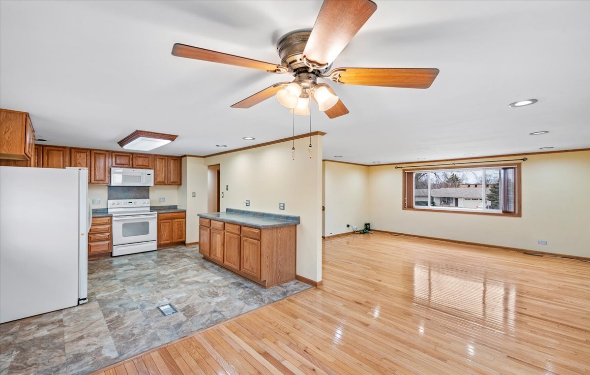 313 Springinsguth Road Schaumburg, IL 60193 - Photo 8 of 39 a view of a kitchen with a sink cabinets and wooden floor