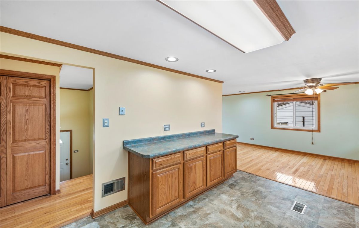 313 Springinsguth Road Schaumburg, IL 60193 - Photo 10 of 39 a view of a refrigerator a sink and wooden floor