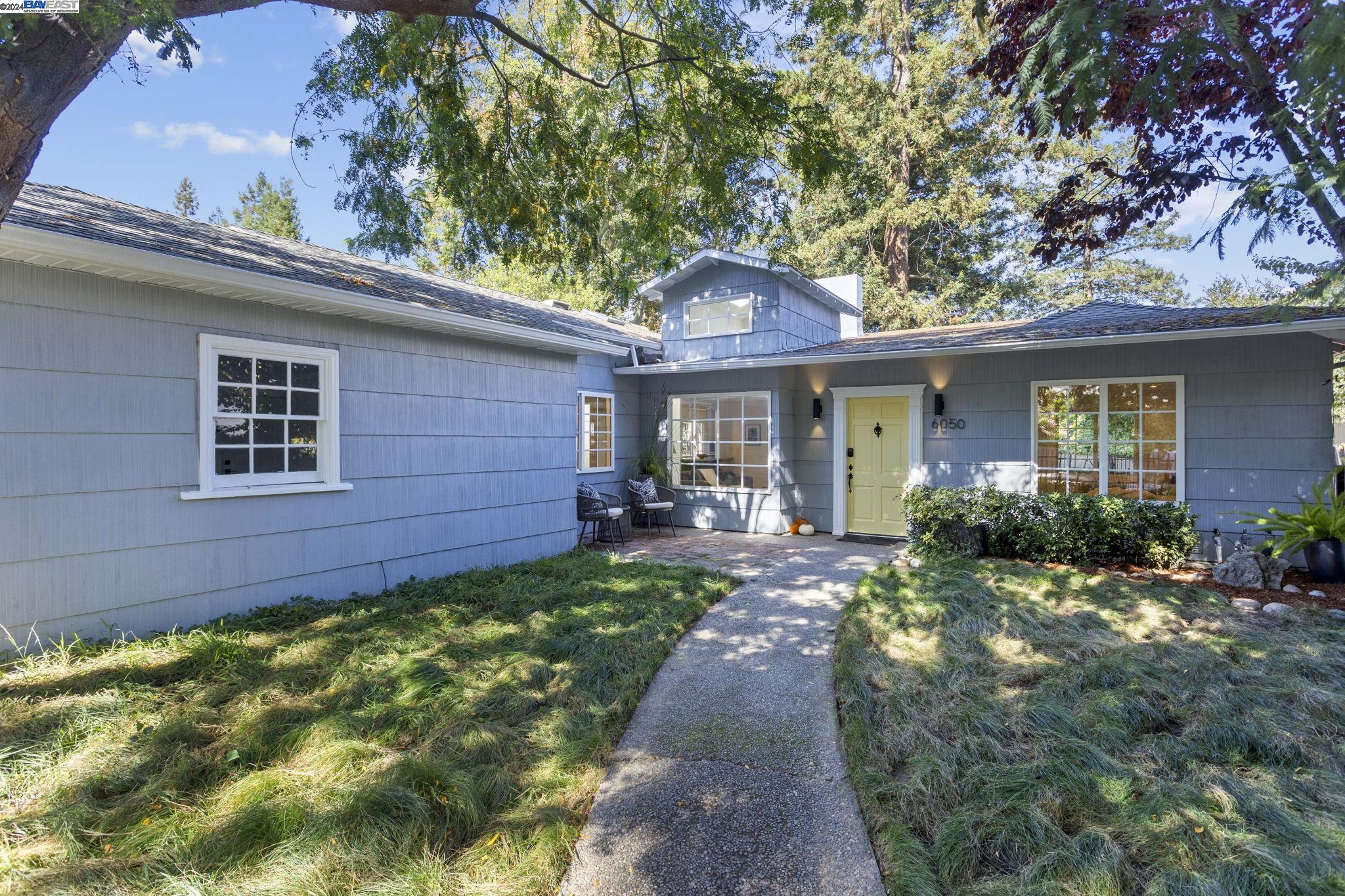 6050 Johnston Drive Oakland, CA 94611 - Photo 1 of 1 a front view of a house with a garden