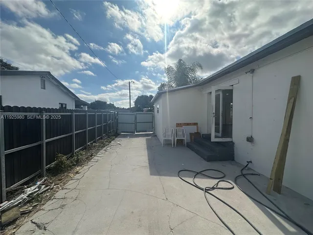 a view of a porch with furniture and a yard