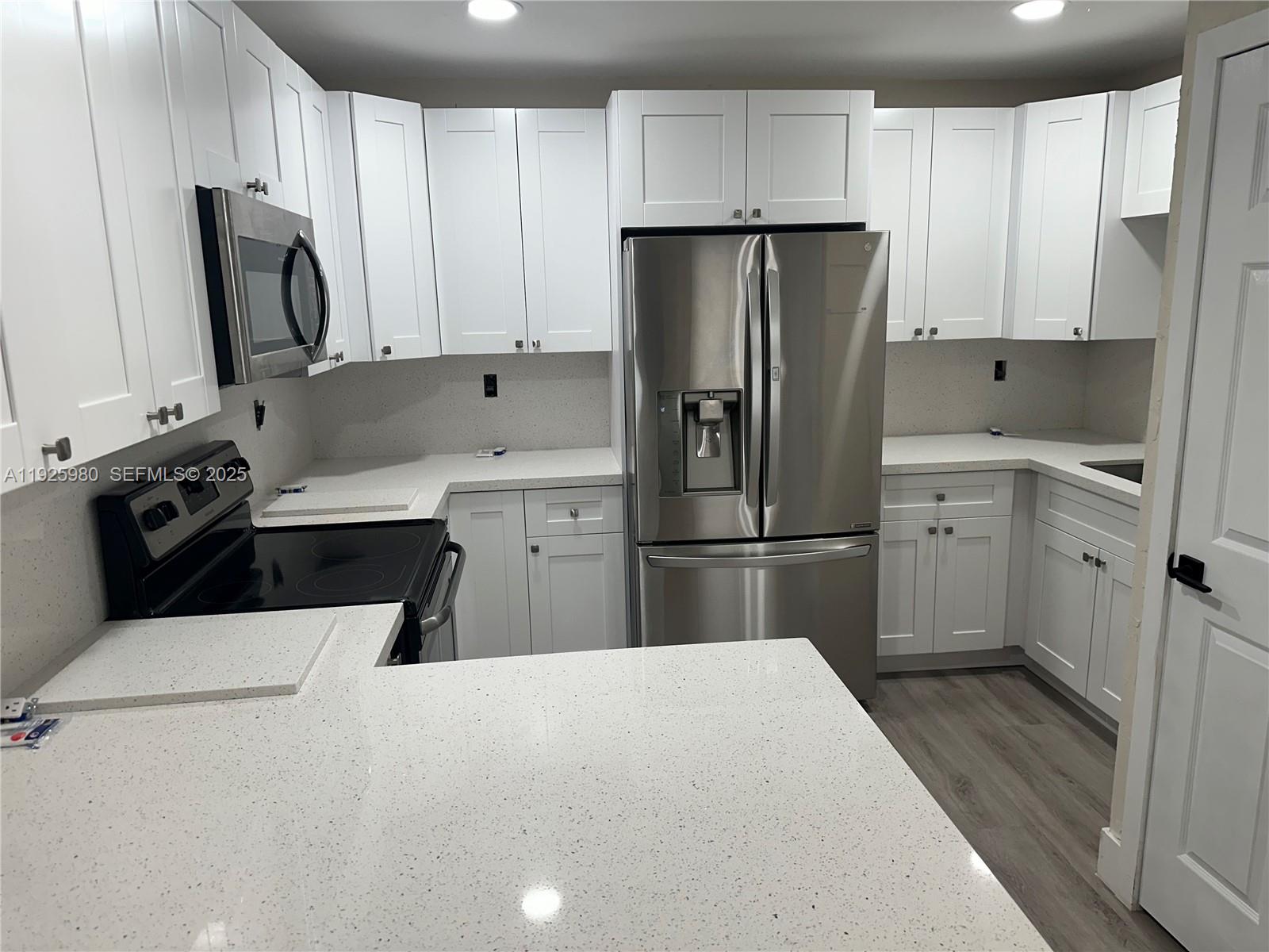 659 East 19th Street, Unit 659 Hialeah, FL 33013 - Photo 21 of 26 a kitchen with a sink a stove a refrigerator and cabinets