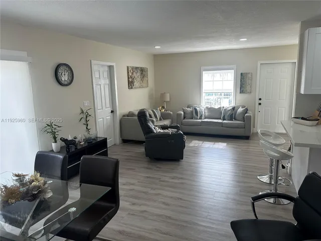 a living room with furniture or couch and a wooden floor