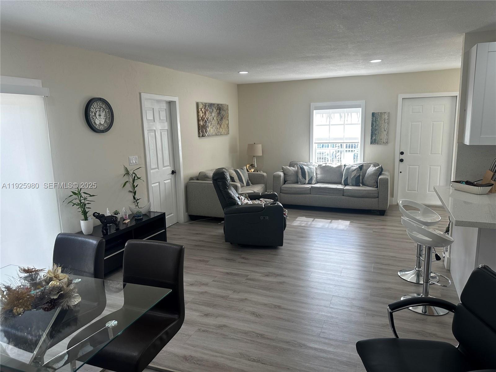 659 East 19th Street, Unit 659 Hialeah, FL 33013 - Photo 3 of 26 a living room with furniture or couch and a wooden floor