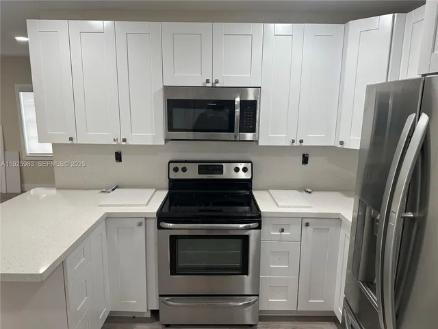 a kitchen with a sink stove and refrigerator