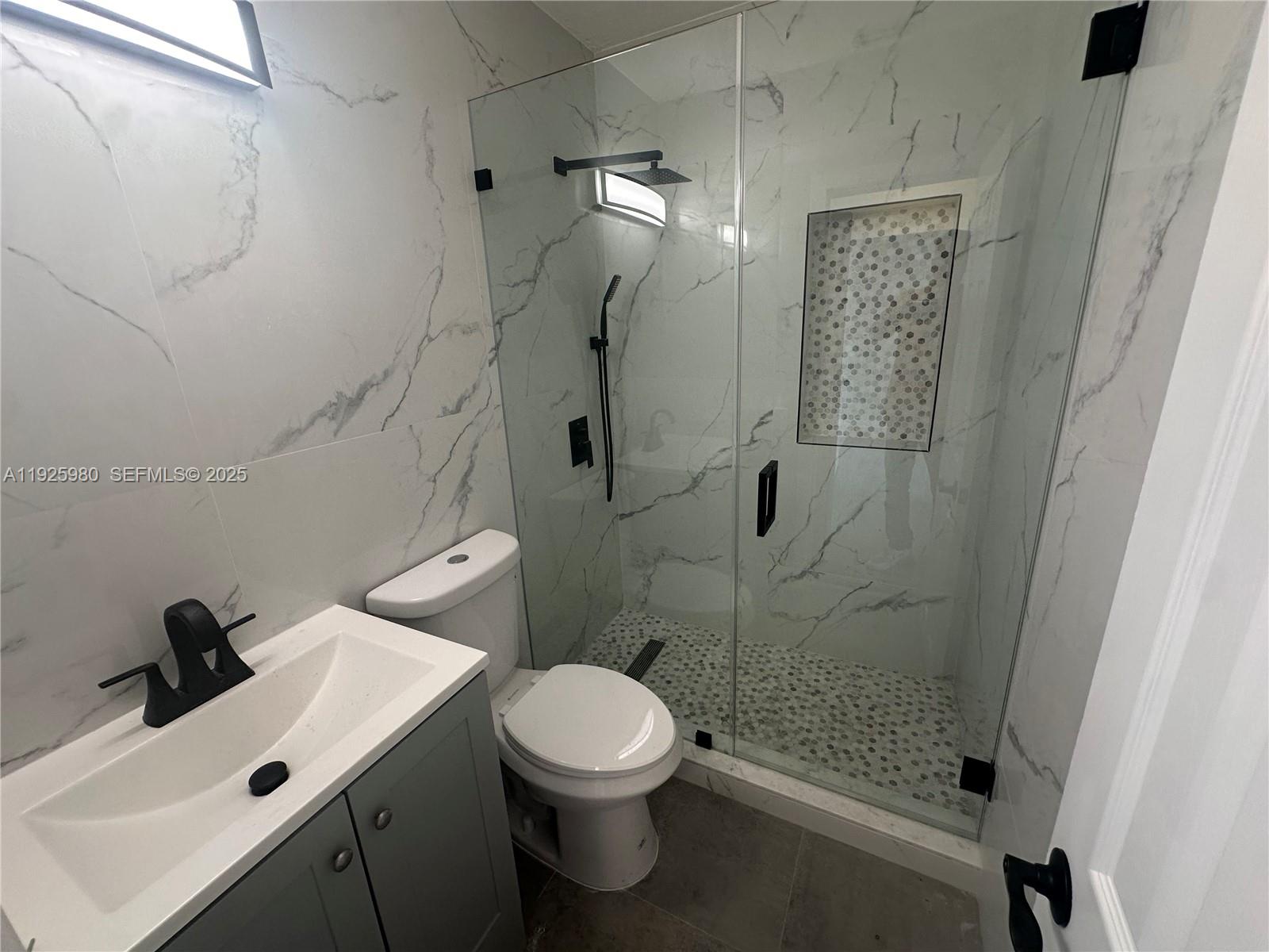 659 East 19th Street, Unit 659 Hialeah, FL 33013 - Photo 8 of 26 a bathroom with a sink toilet and shower