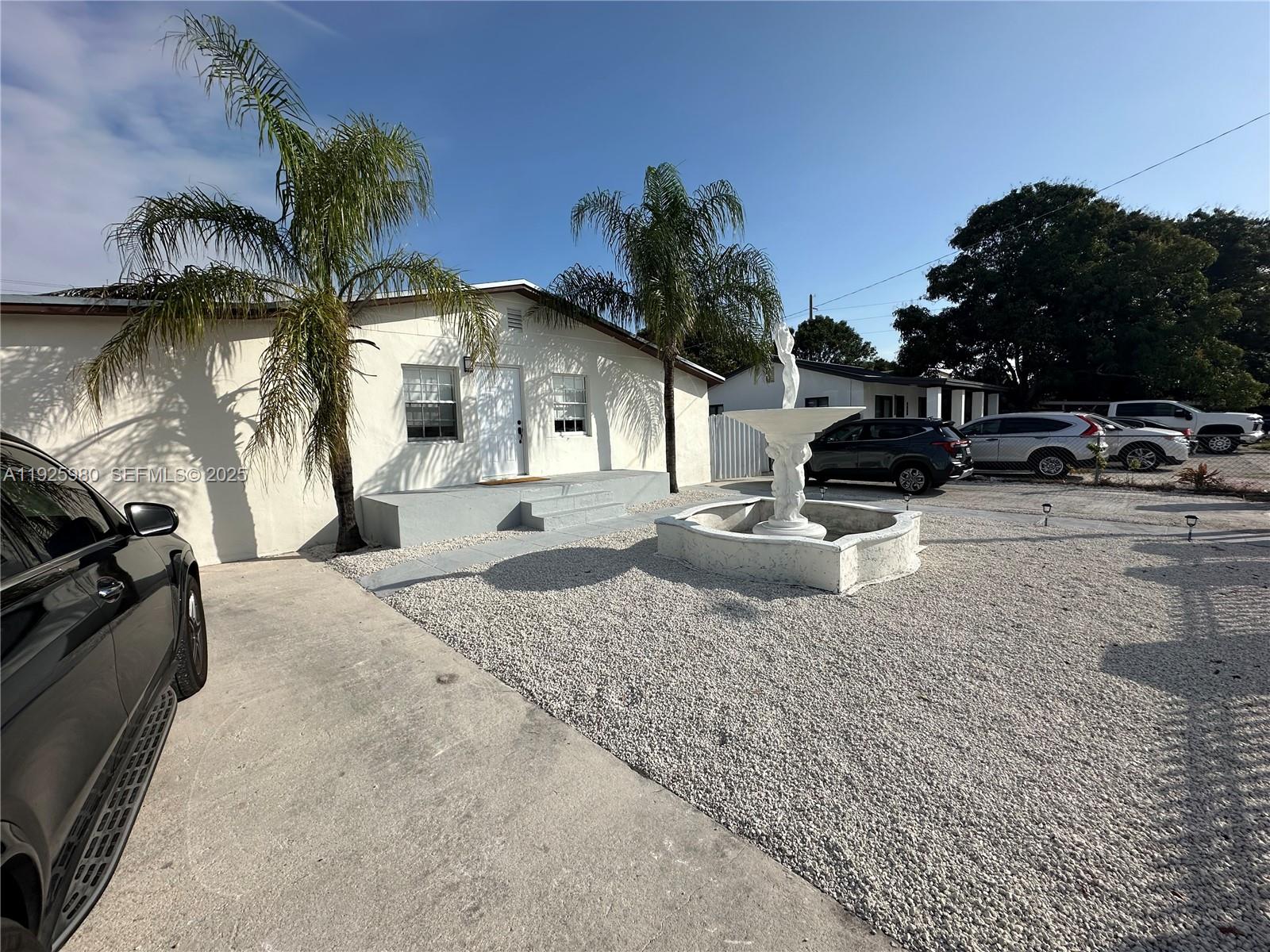 659 East 19th Street, Unit 659 Hialeah, FL 33013 - Photo 9 of 26 a front view of a house with a yard and garage