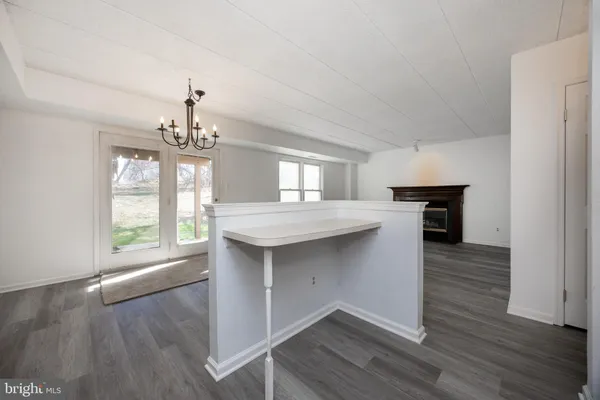 a kitchen with kitchen island granite countertop a sink cabinets and wooden floor