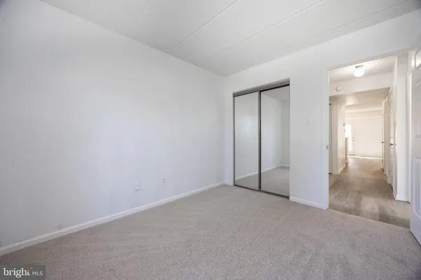 an empty room with closet area