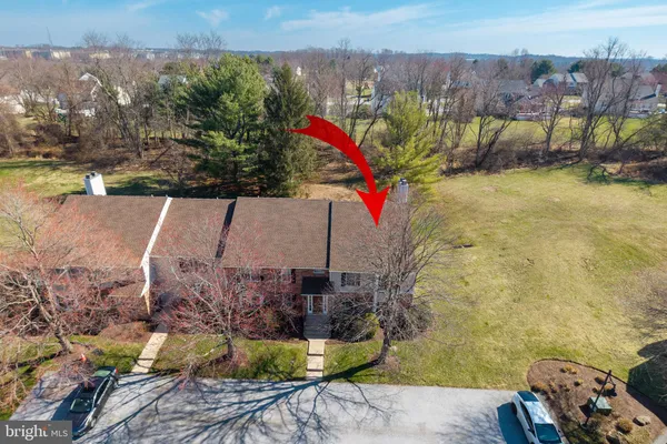 an aerial view of a house with a yard and lake view