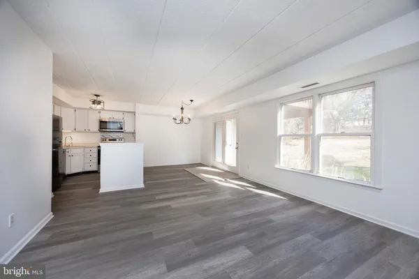 a view of a kitchen with a stove cabinets and wooden floor